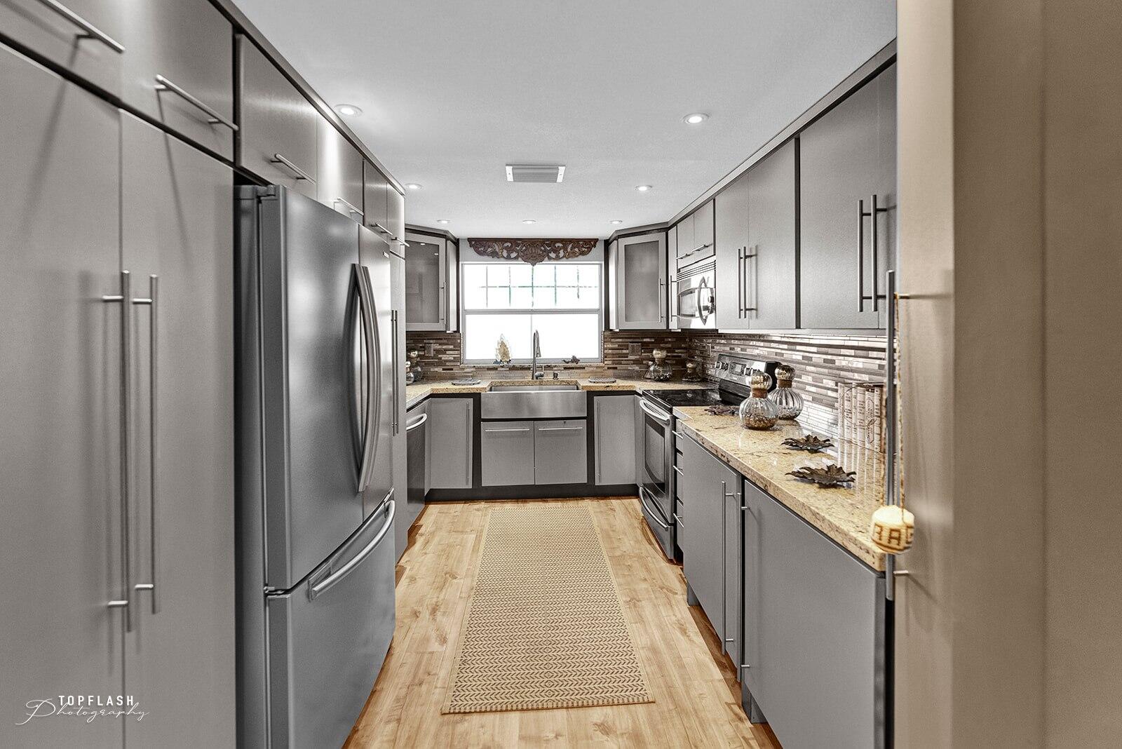 a kitchen with stainless steel appliances granite countertop a refrigerator a sink dishwasher and a stove top oven