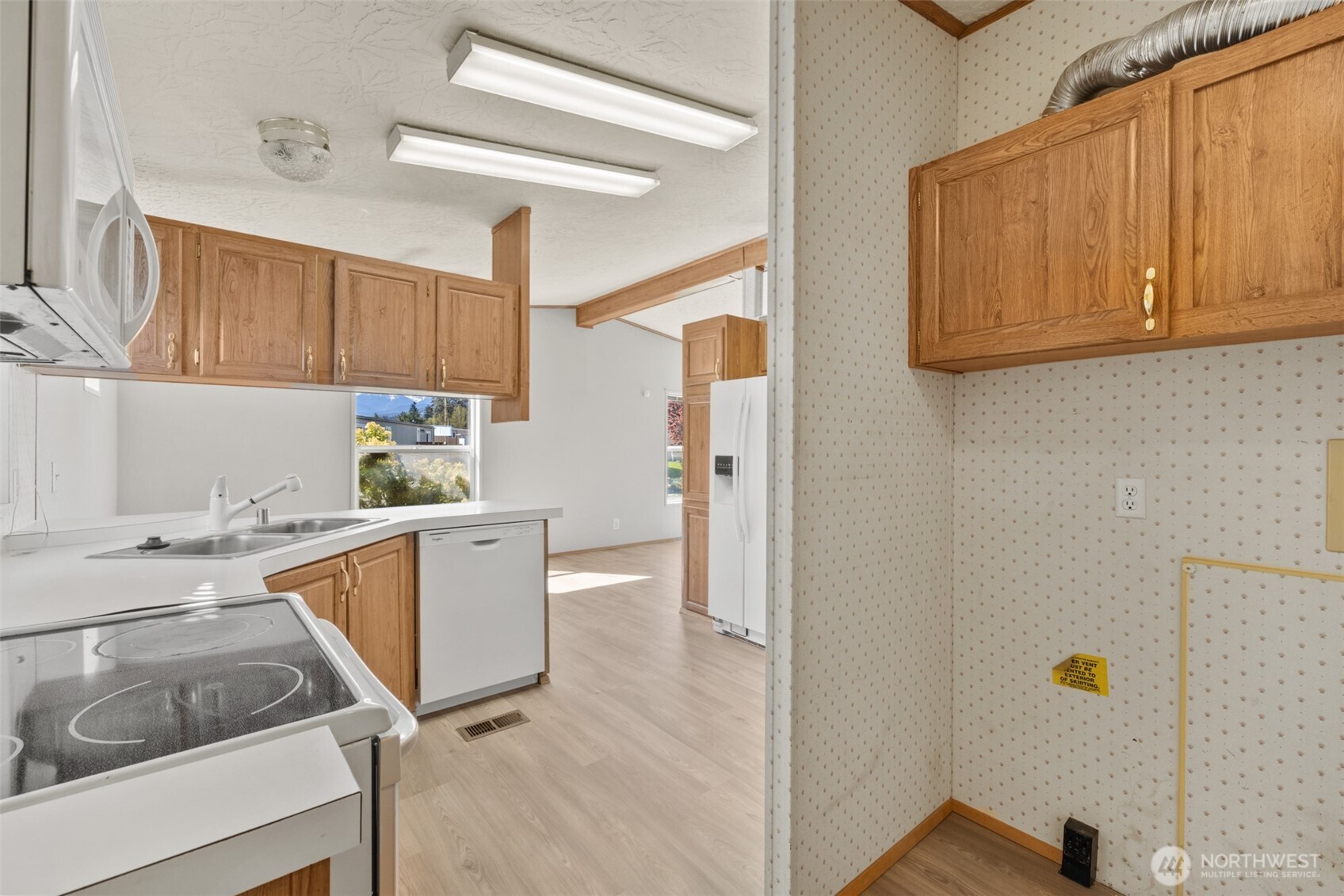 491 Mill Road, Unit 4 Sequim, WA 98382 - Photo 14 of 33 a kitchen with a sink cabinets and window