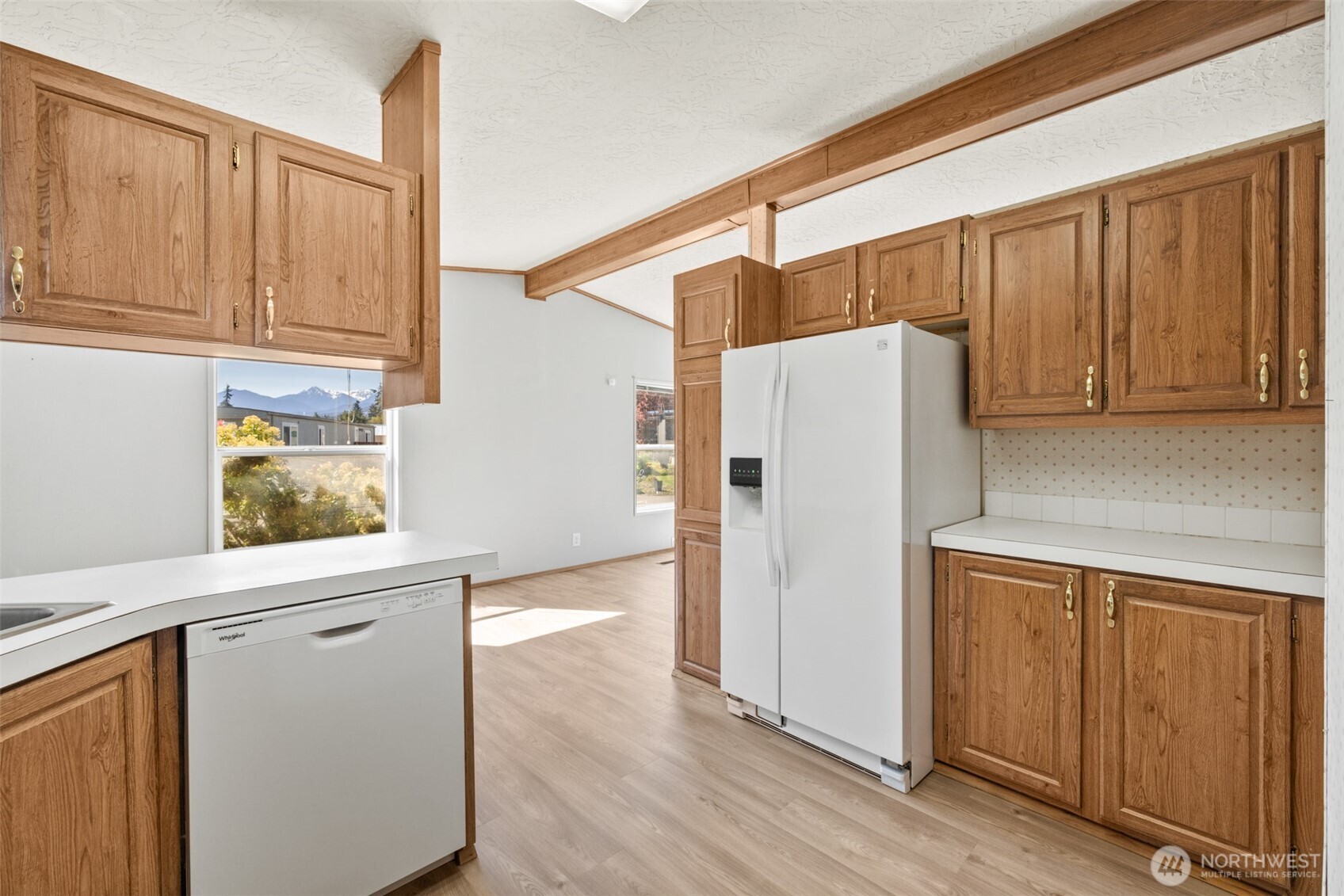 491 Mill Road, Unit 4 Sequim, WA 98382 - Photo 15 of 33 a white refrigerator freezer sitting inside of a kitchen