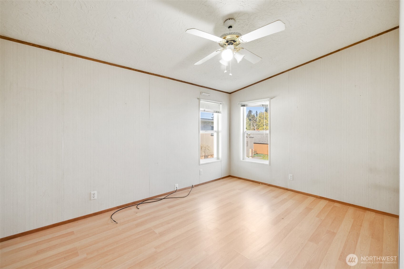 491 Mill Road, Unit 4 Sequim, WA 98382 - Photo 18 of 33 an empty room with wooden floor fan and windows