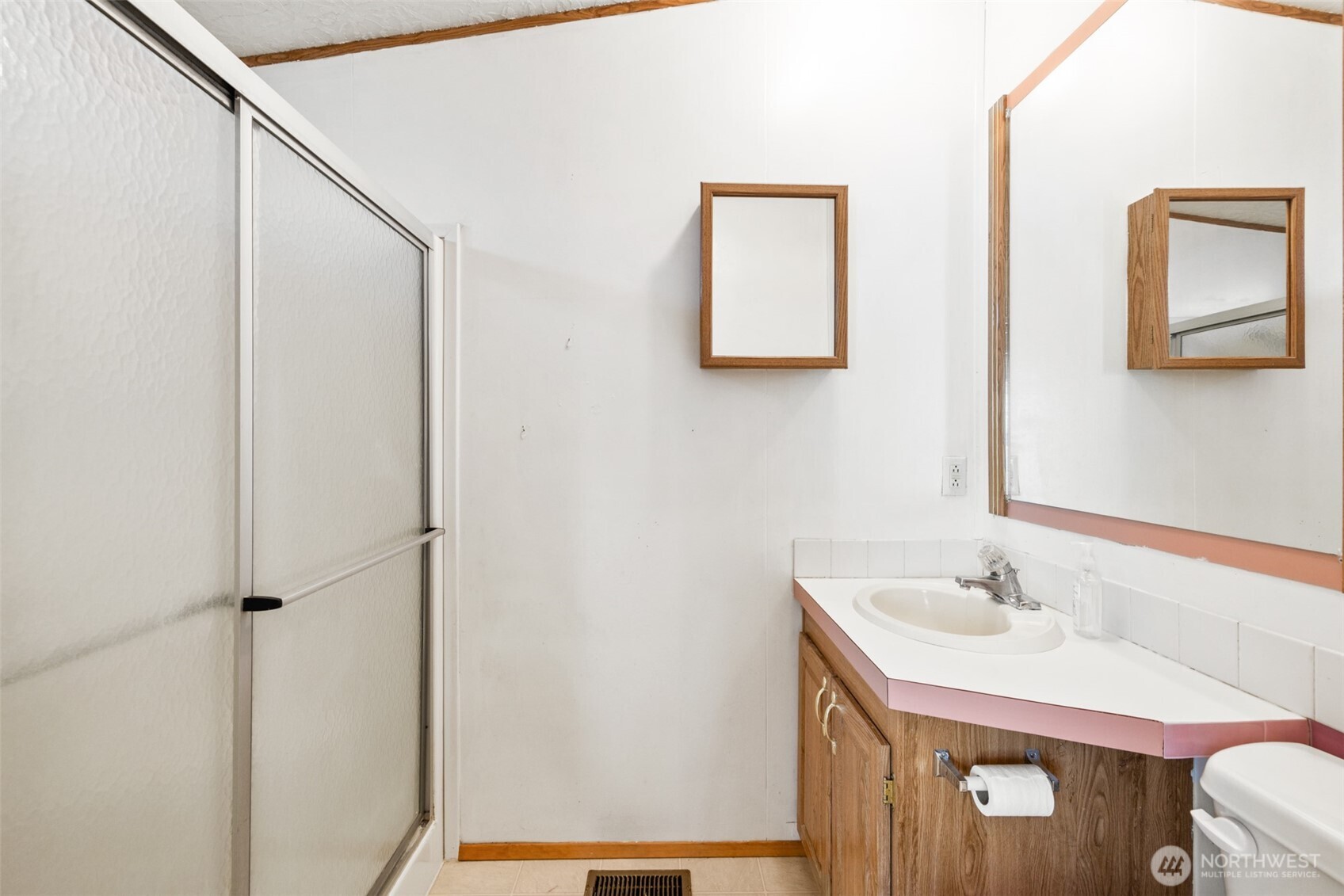 491 Mill Road, Unit 4 Sequim, WA 98382 - Photo 23 of 33 a bathroom with a sink and a mirror