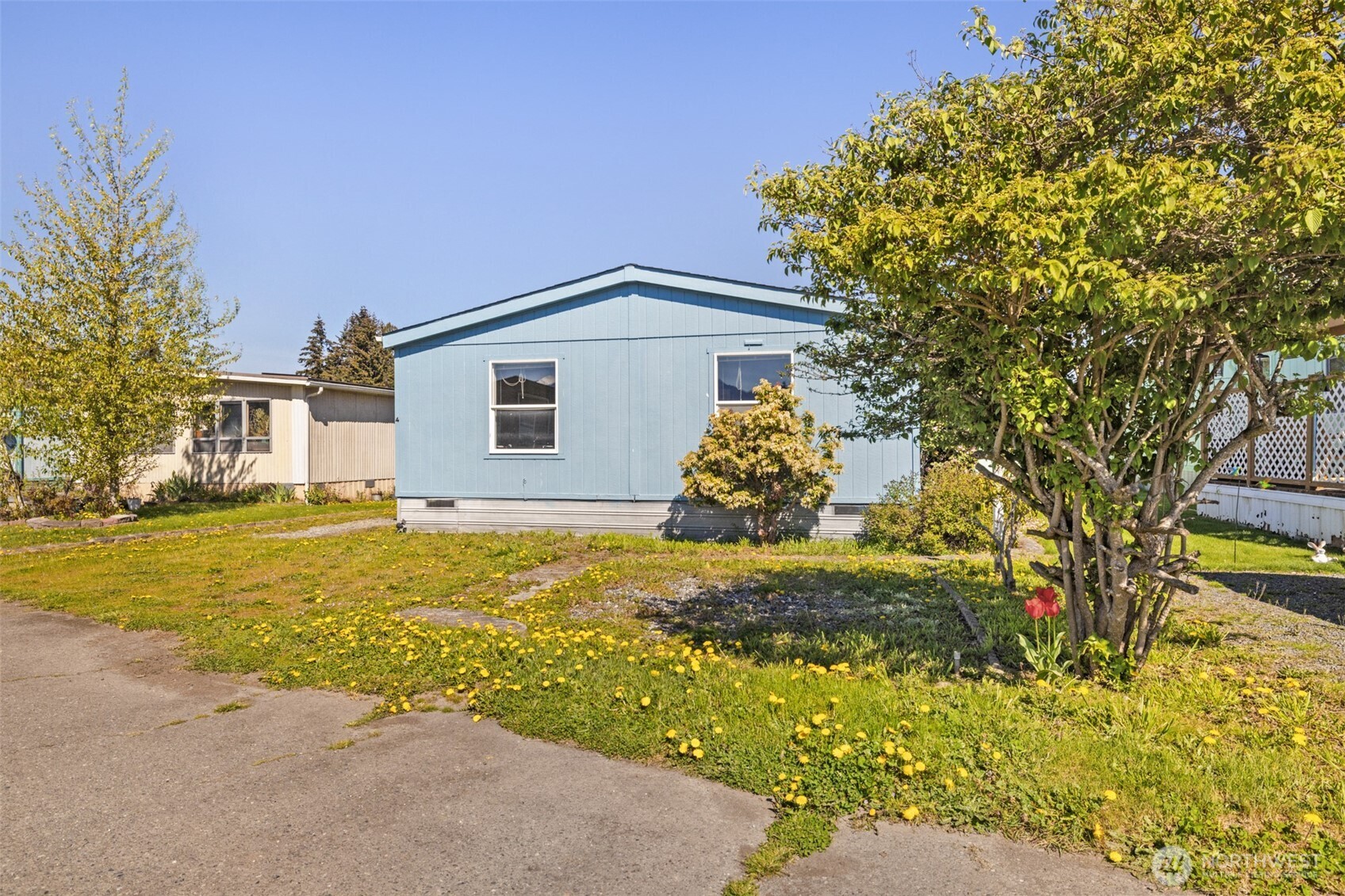 491 Mill Road, Unit 4 Sequim, WA 98382 - Photo 29 of 33 a front view of a house with a yard