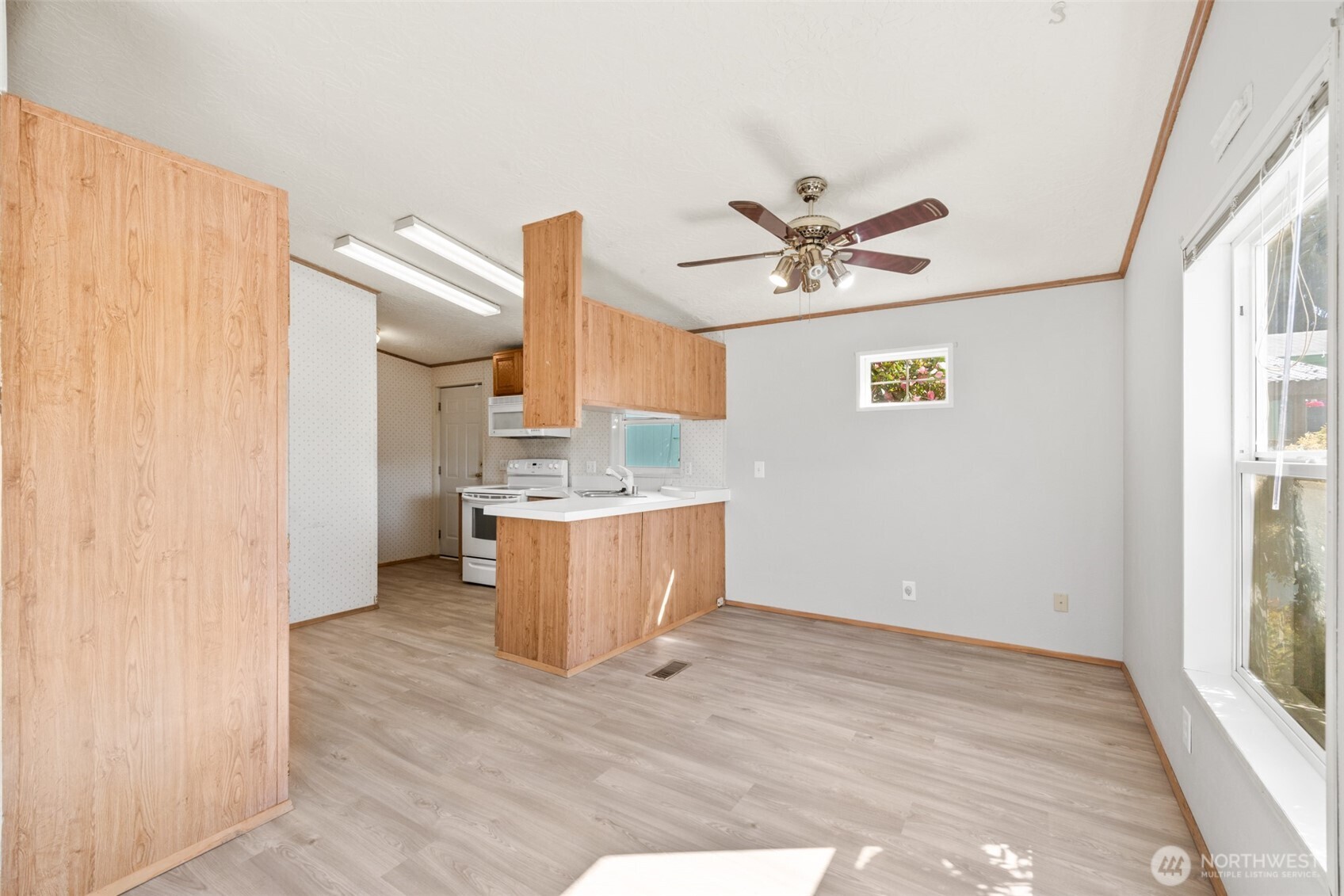 491 Mill Road, Unit 4 Sequim, WA 98382 - Photo 7 of 33 a view of a kitchen with a sink and a window