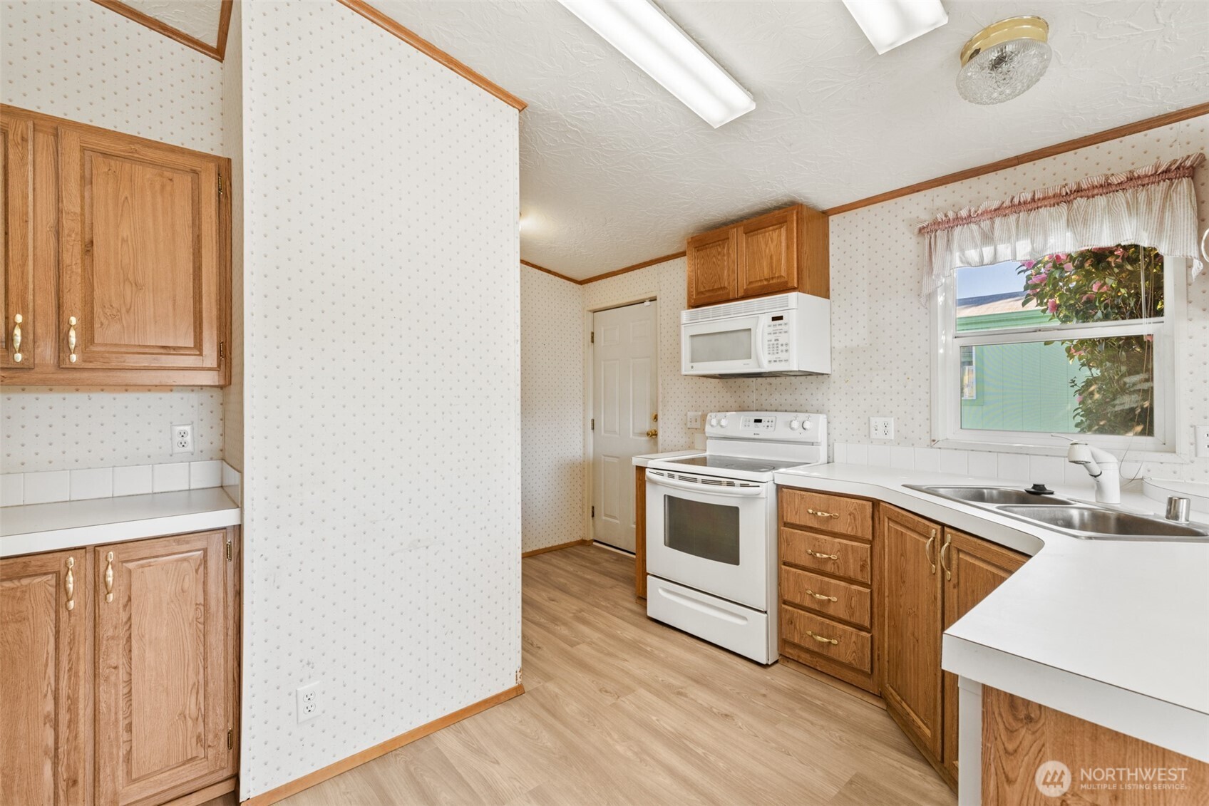 491 Mill Road, Unit 4 Sequim, WA 98382 - Photo 10 of 33 a kitchen with a stove a sink and a microwave
