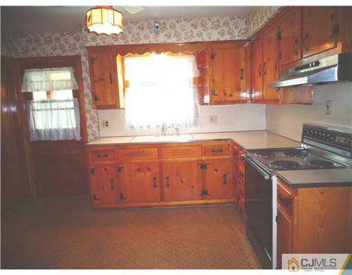 59 Orchard Road Middlesex, NJ 08846 - Photo 7 of 24 a kitchen with stainless steel appliances granite countertop a stove a sink and a microwave