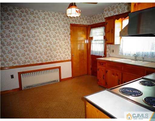 59 Orchard Road Middlesex, NJ 08846 - Photo 8 of 24 a view of kitchen with cabinets and window