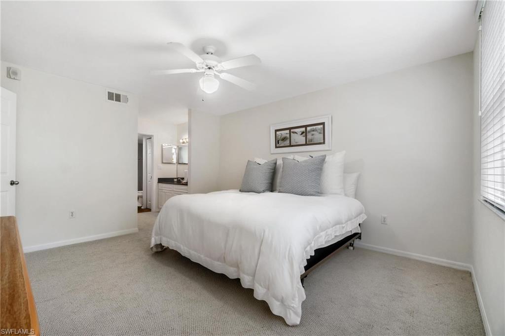 285 Naples Cove Drive, Unit 1106 Naples, FL 34110 - Photo 18 of 46 a bedroom with a bed and window