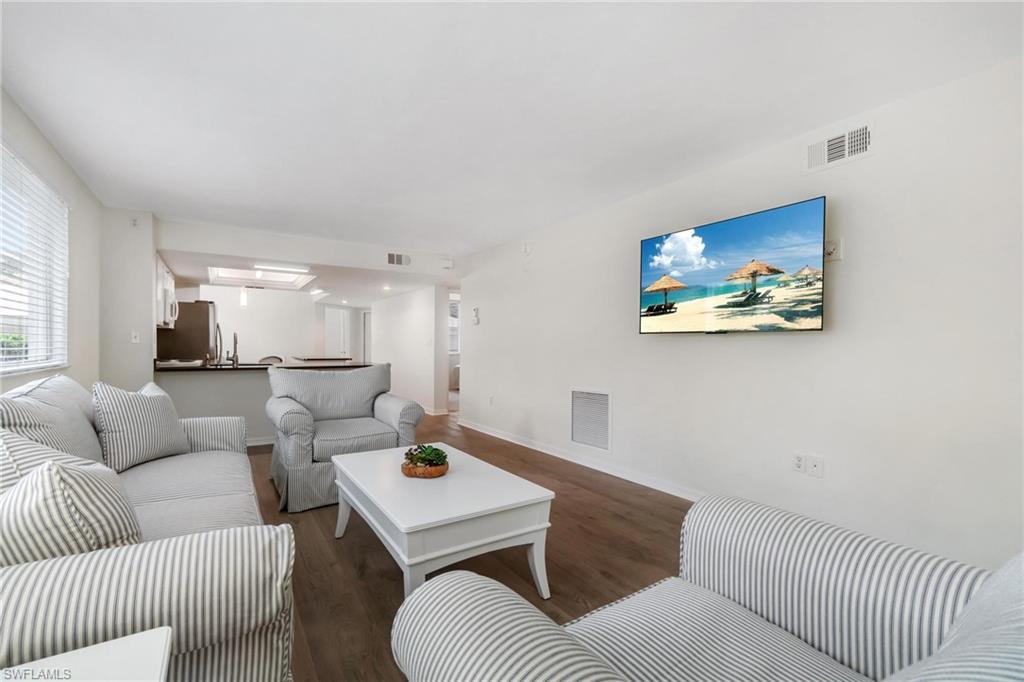 285 Naples Cove Drive, Unit 1106 Naples, FL 34110 - Photo 2 of 46 a living room with furniture and a couch