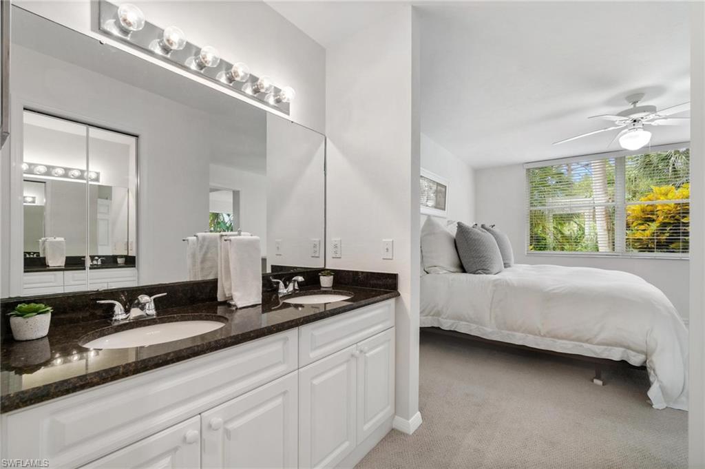 285 Naples Cove Drive, Unit 1106 Naples, FL 34110 - Photo 23 of 46 a bedroom with a bed and a large mirror