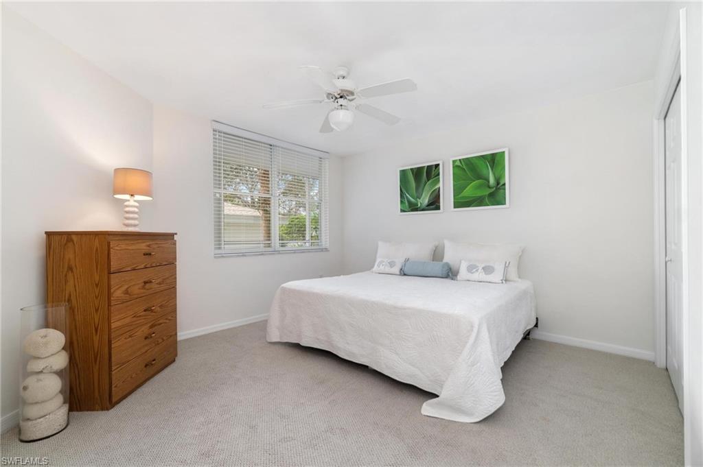 285 Naples Cove Drive, Unit 1106 Naples, FL 34110 - Photo 24 of 46 a bedroom with a bed and a window