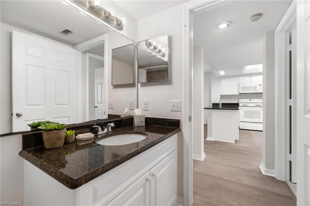 285 Naples Cove Drive, Unit 1106 Naples, FL 34110 - Photo 26 of 46 a kitchen with a sink and cabinets