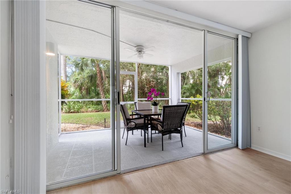 285 Naples Cove Drive, Unit 1106 Naples, FL 34110 - Photo 28 of 46 a dining room with furniture water view and a floor to ceiling window