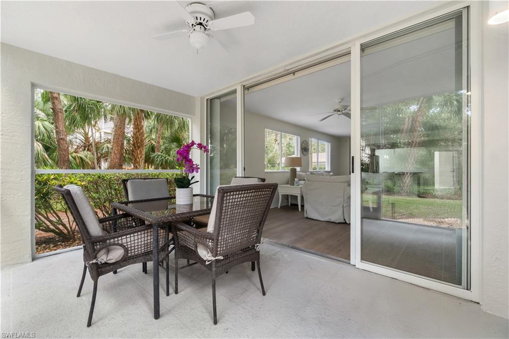 285 Naples Cove Drive, Unit 1106 Naples, FL 34110 - Photo 30 of 46 a dining room with furniture a chandelier and fireplace