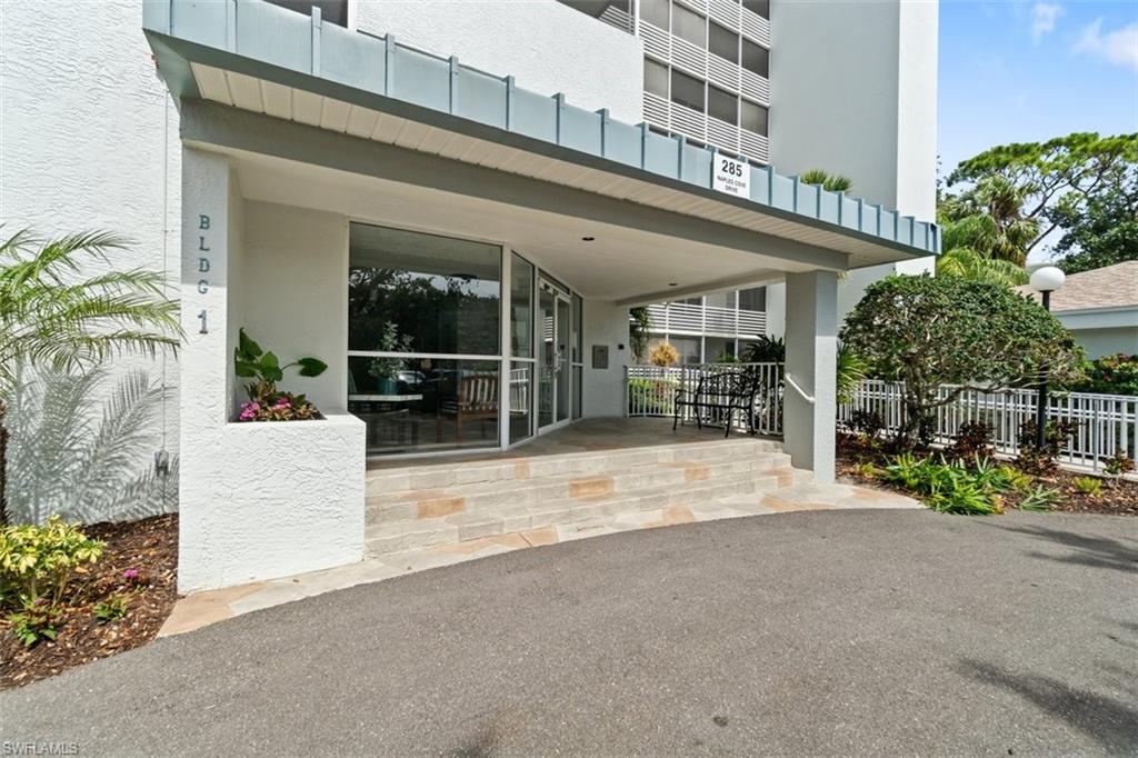 285 Naples Cove Drive, Unit 1106 Naples, FL 34110 - Photo 34 of 46 front view of a building with a garden