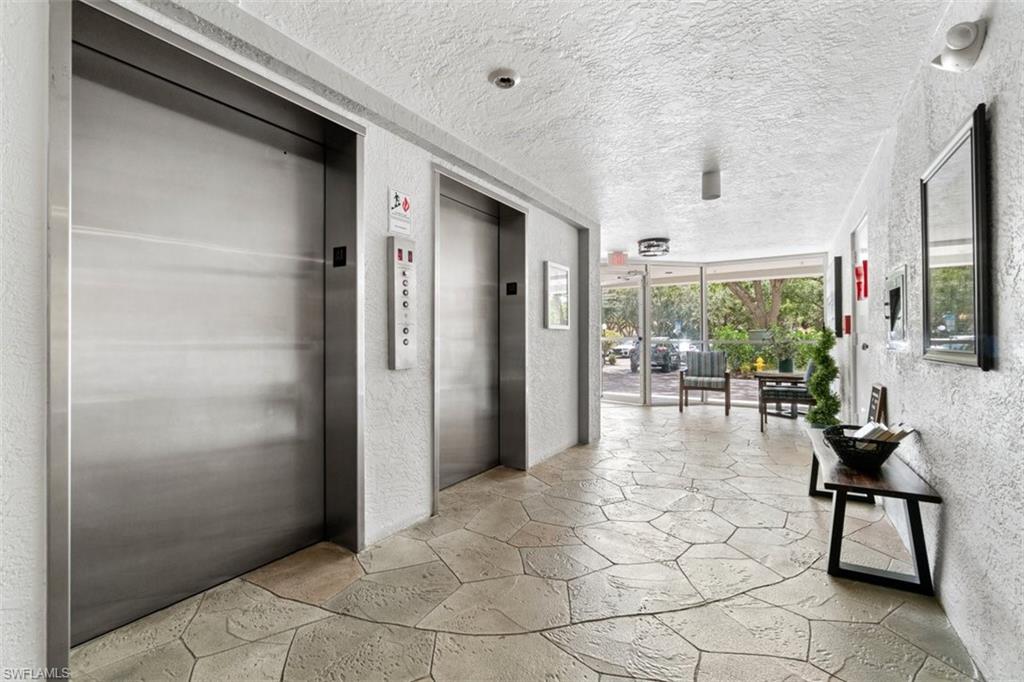 285 Naples Cove Drive, Unit 1106 Naples, FL 34110 - Photo 35 of 46 a view of livingroom with furniture and floor to ceiling window