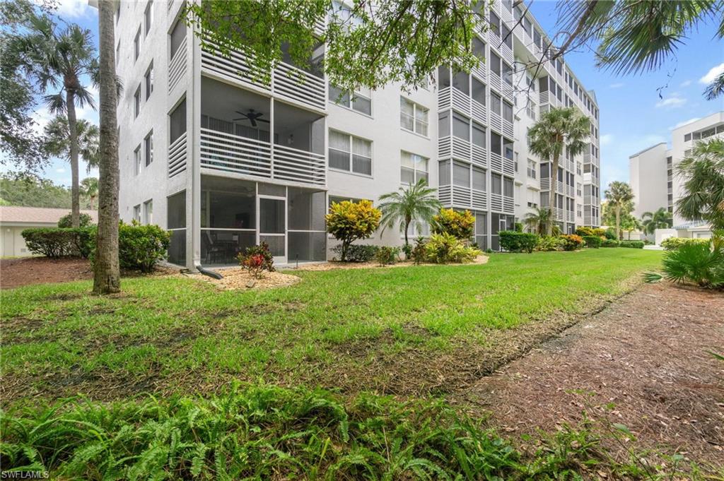 285 Naples Cove Drive, Unit 1106 Naples, FL 34110 - Photo 45 of 46 a view of a house with a yard