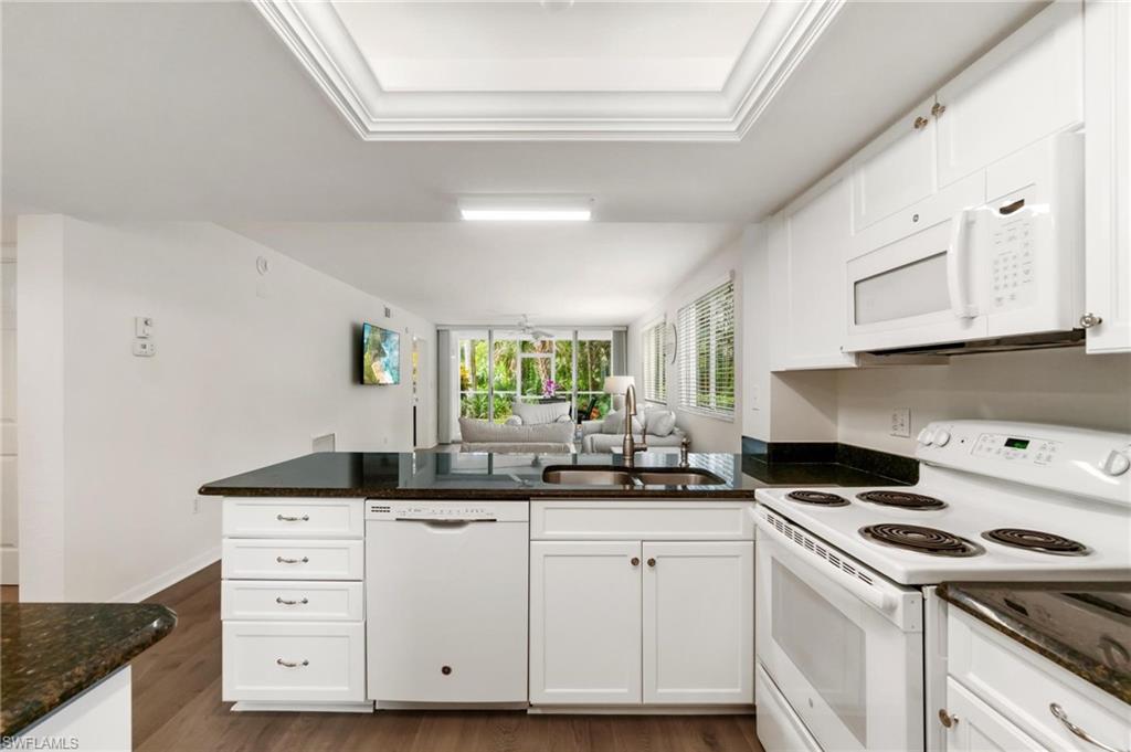 285 Naples Cove Drive, Unit 1106 Naples, FL 34110 - Photo 6 of 46 a kitchen with cabinets appliances a sink and a window