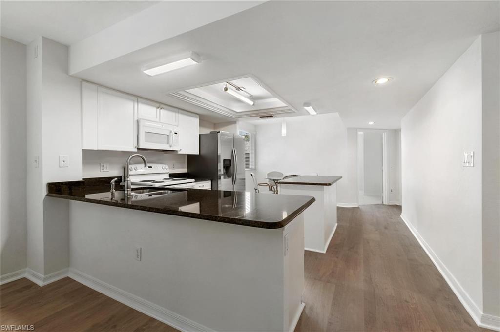 285 Naples Cove Drive, Unit 1106 Naples, FL 34110 - Photo 8 of 46 a kitchen with stainless steel appliances a sink stove and cabinets