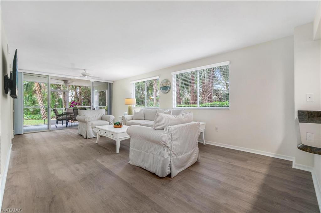 285 Naples Cove Drive, Unit 1106 Naples, FL 34110 - Photo 10 of 46 a living room with furniture and a large window