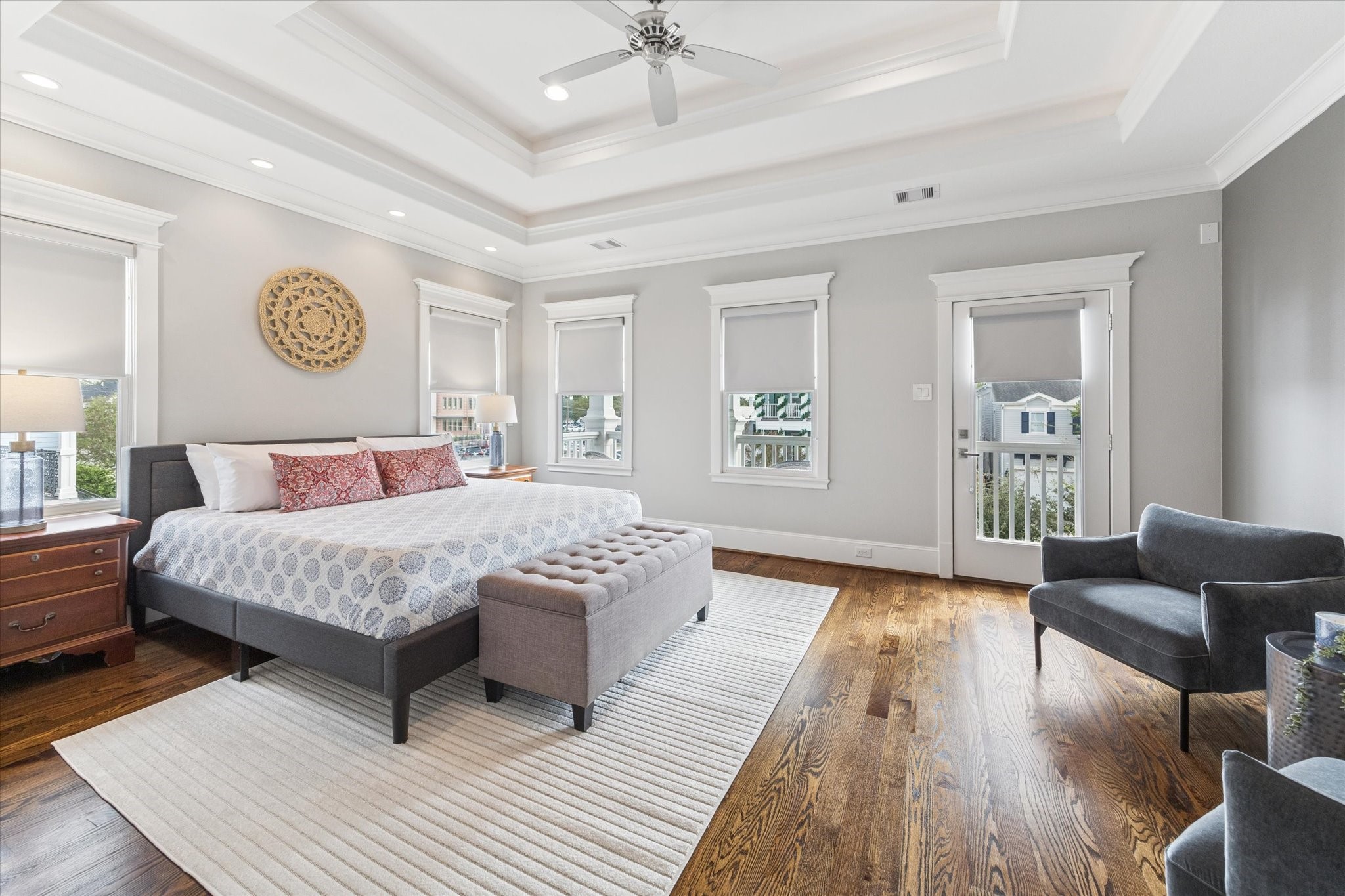 209 West 24th Street Houston, TX 77008 - Photo 17 of 36 The luxurious primary suite feels like a true escape, featuring porch access, double-tray ceiling, two walk-in closets and hardwood floors.