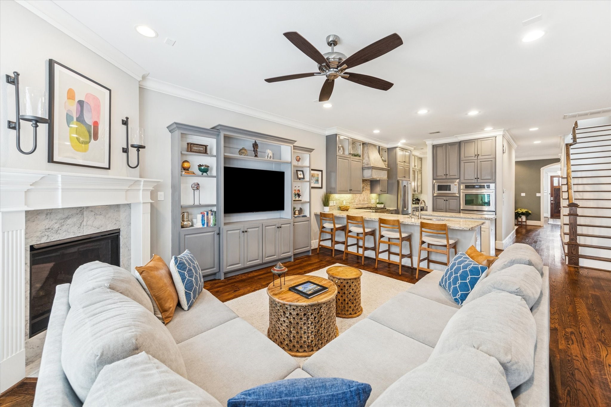 209 West 24th Street Houston, TX 77008 - Photo 2 of 36 An open living room anchored by a cozy fireplace, complemented by built-in cabinetry and shelves for displaying favorite décor and collections.