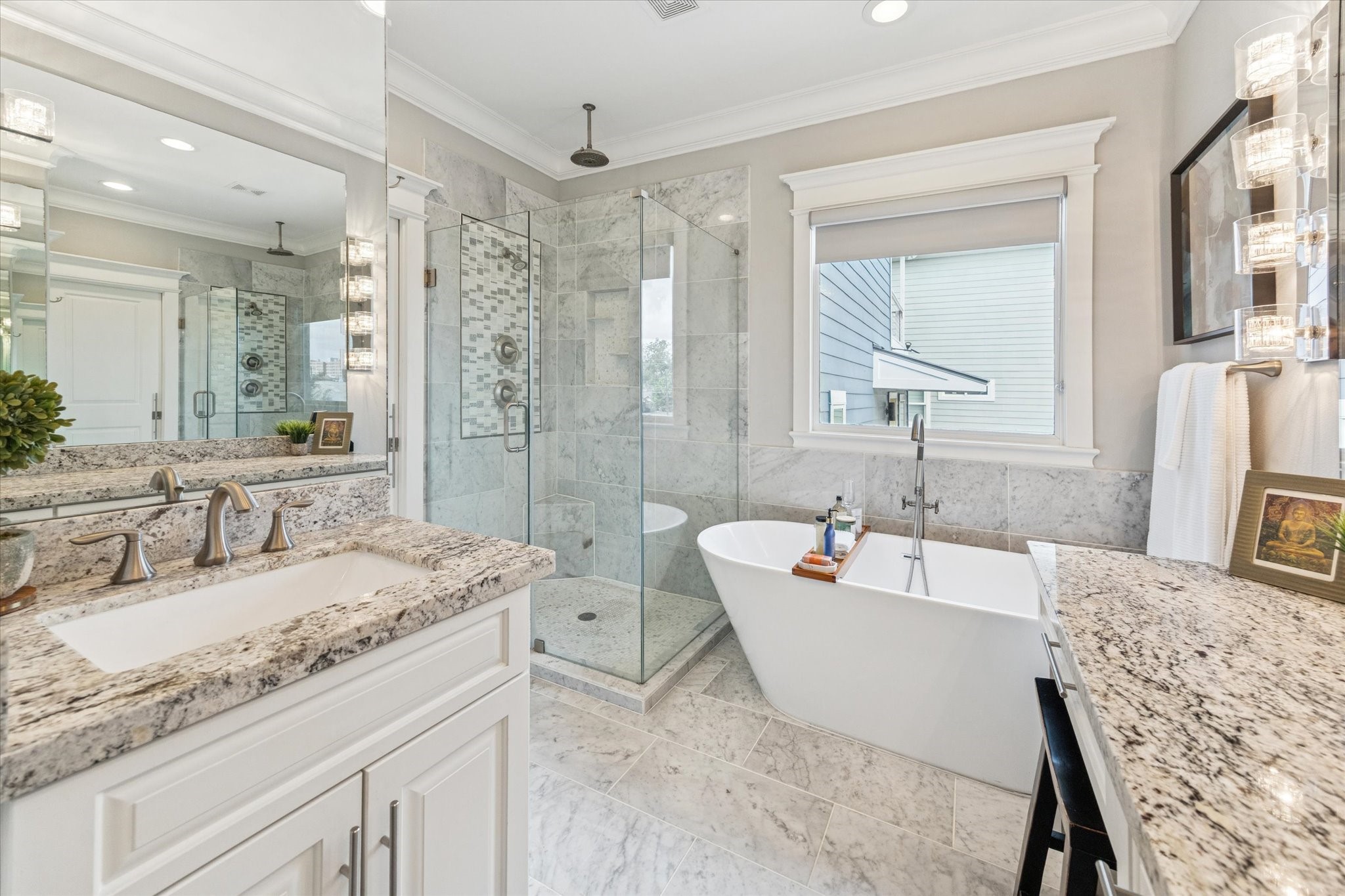 209 West 24th Street Houston, TX 77008 - Photo 20 of 36 Enjoy a true at-home spa experience in this stunning bathroom, complete with dual vanities, a freestanding soaking tub, Italian marble tile, and a glass-enclosed shower with dual shower heads, including a rain head.