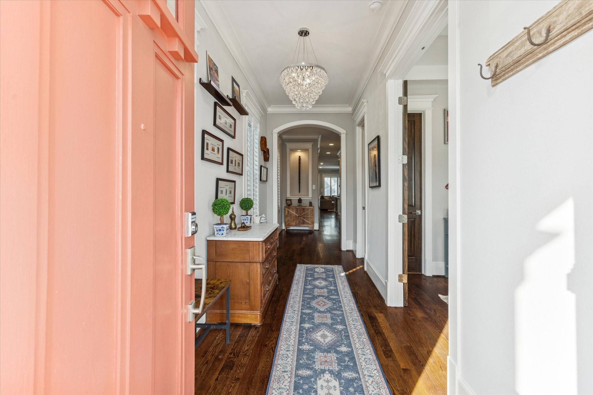 209 West 24th Street Houston, TX 77008 - Photo 32 of 36 From the moment you walk in, you’ll notice the hardwood floors, stylish light fixture, and detailed millwork.