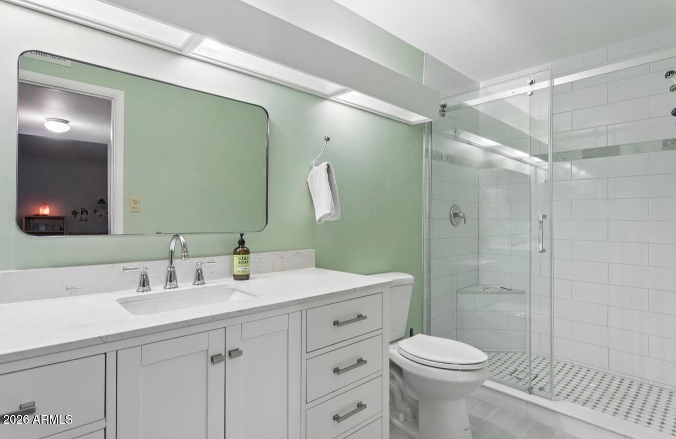 1030 East Bethany Home Road, Unit 6 Phoenix, AZ 85014 - Photo 4 of 15 a bathroom with a sink a toilet and shower