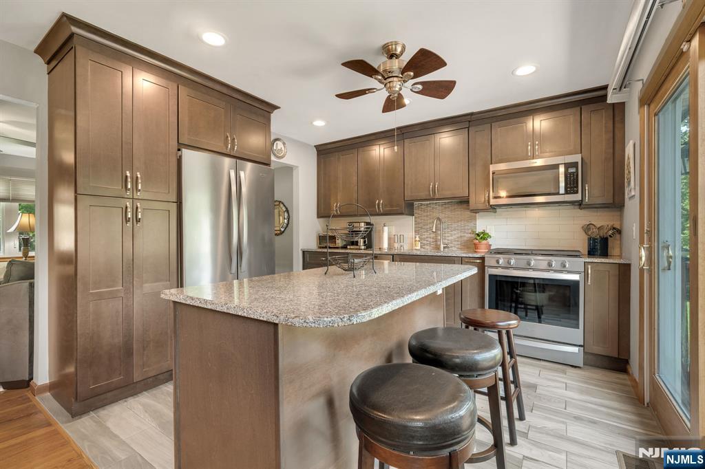 55 Marcia Road Ringwood, NJ 07456 - Photo 6 of 42 a kitchen with cabinets a sink stainless steel appliances and a counter top space