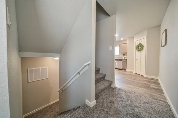 a view of entryway and hall with wooden floor