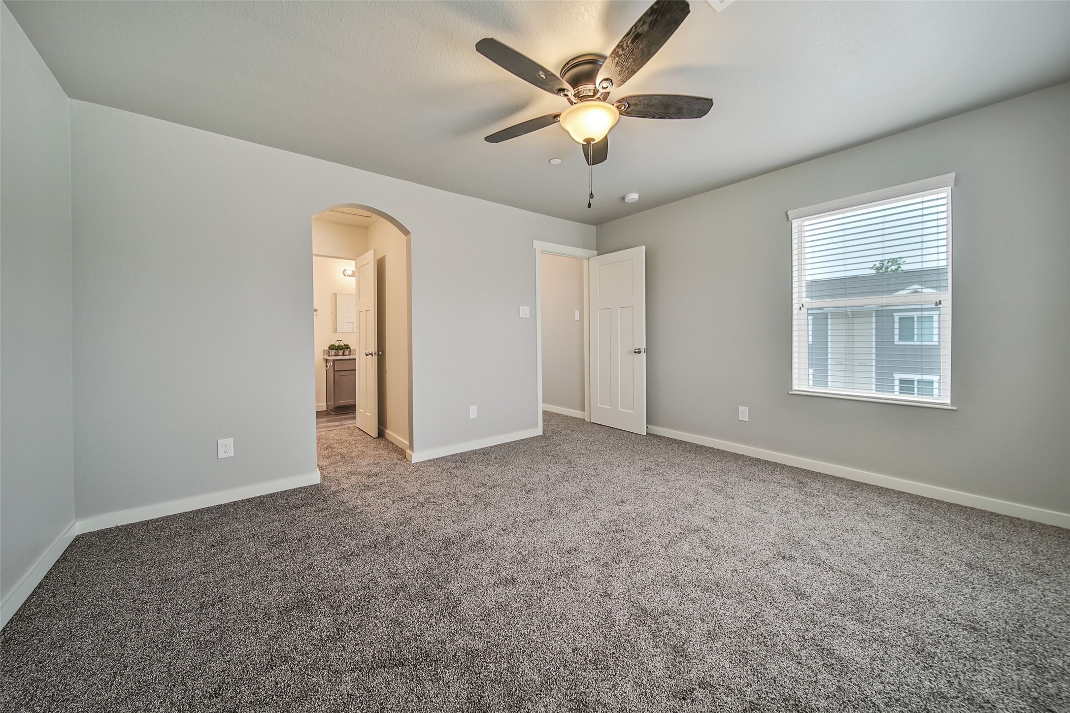 21155 Gosling Road, Unit 15 CD Spring, TX 77388 - Photo 21 of 34 an empty room with chandelier fan and windows