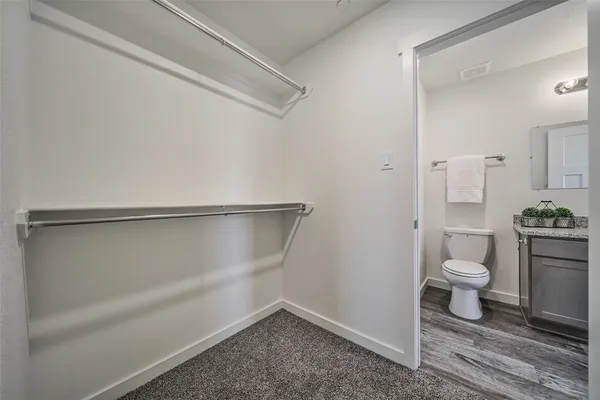 a bathroom with a granite countertop toilet and a shower