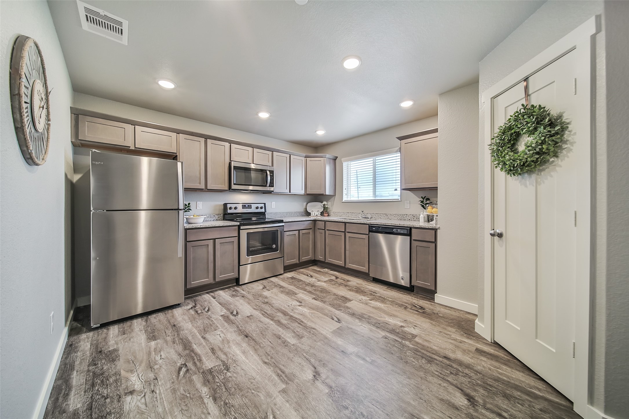 21155 Gosling Road, Unit 15 CD Spring, TX 77388 - Photo 8 of 34 a kitchen with granite countertop stainless steel appliances a refrigerator and a sink