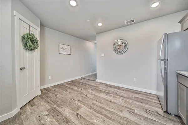 a view of an empty room with wooden floor
