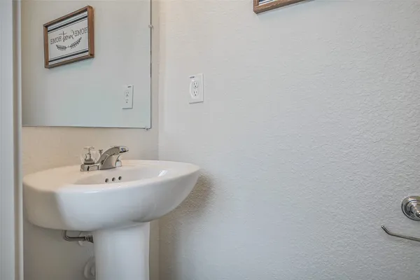 a bathroom with a sink a mirror and toilet