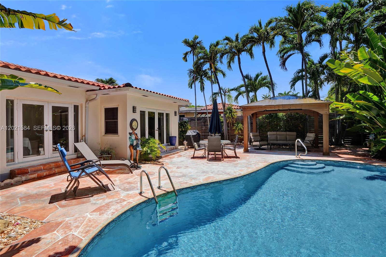 811 Northeast 73rd Street Miami, FL 33138 - Photo 25 of 51 a view of a house with swimming pool and sitting area