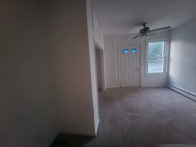 an empty room with windows and closet