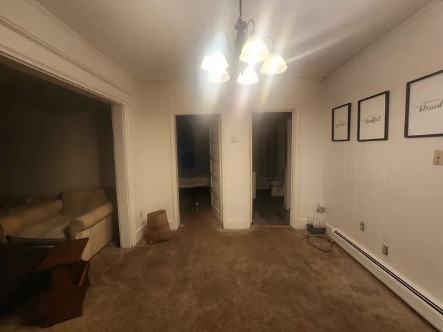 an empty room with furniture and windows