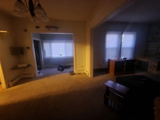 a view of a livingroom with window and furniture