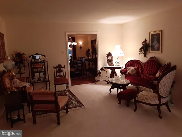 a living room with furniture and a lamp