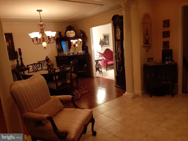 a view of a dining room with furniture and chandelier