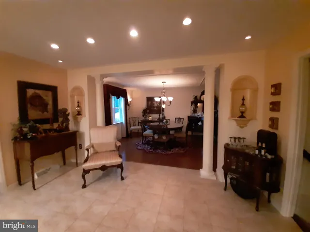 a living room with furniture and a lamp