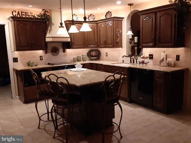 a kitchen with stainless steel appliances a sink stove and refrigerator