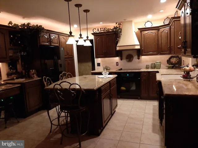 a kitchen with a sink a microwave and cabinets