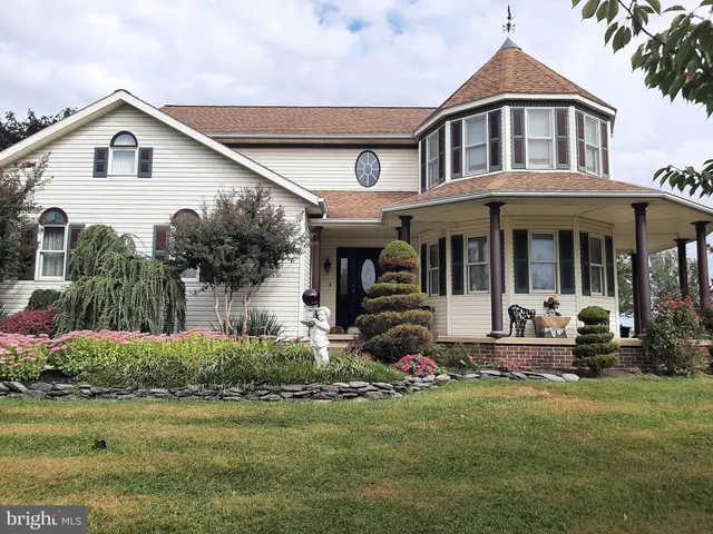 a front view of a house with a garden and porch
