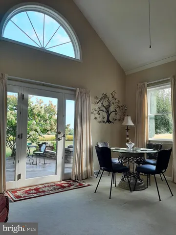 a view of a chairs and table in a balcony