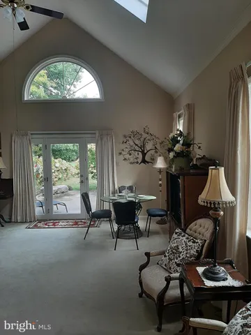 a view of a livingroom with furniture and a hallway