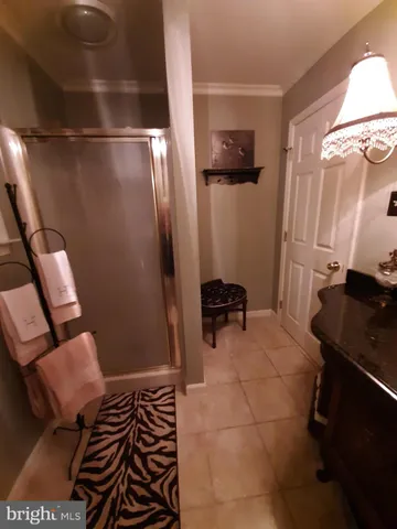 a bedroom with a bed and a lamp with the dresser