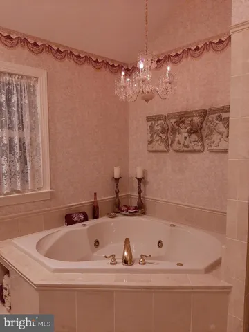 a view of a house with backyard and trees