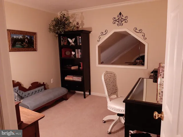 an aerial view of ocean with residential house with outdoor space and trees all around